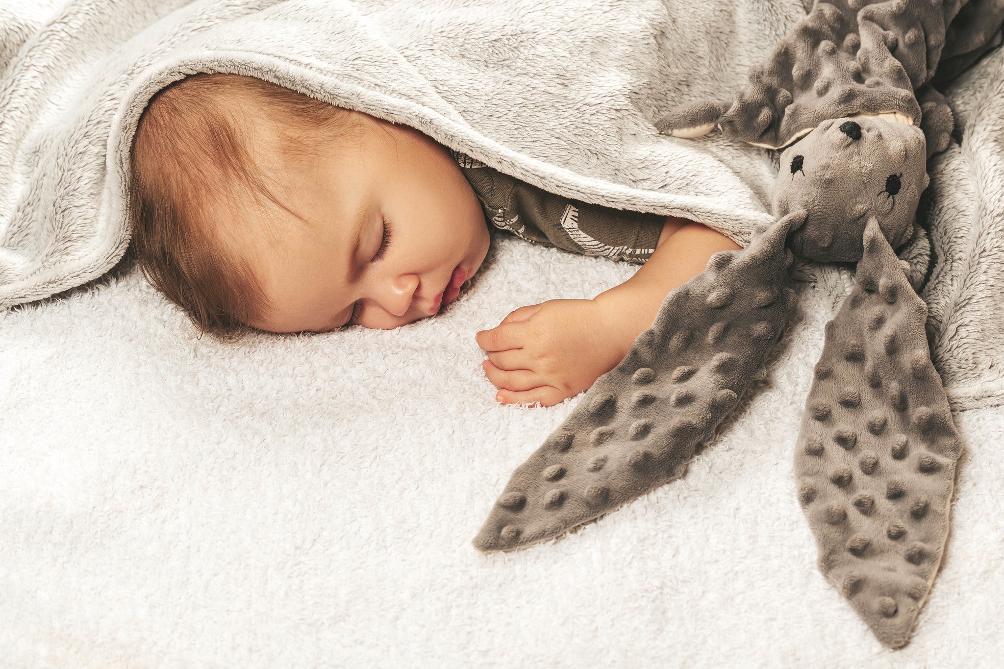 baby sleeping in a minky blanket